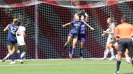 Emily Jensen leaps up to head the ball