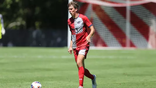 Nick Strangio dribbles up field