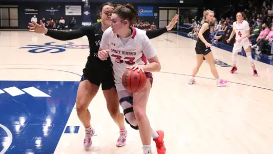 Bamberger drives the lane in pink jersery
