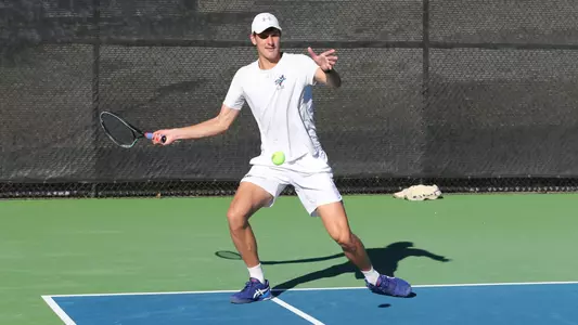 James Watt forehand in right corner of court