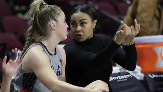 Mariya Moore giving instruction during 2023 WCC Tourney