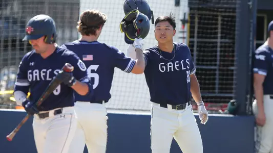 Nathan Chong celebrates a home run with Coleman Schmidt