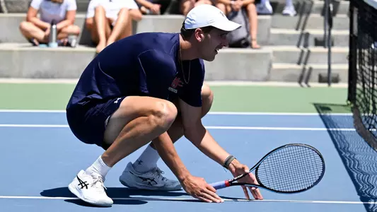 James Watt crouching in front of net in WCC tourney doubles match