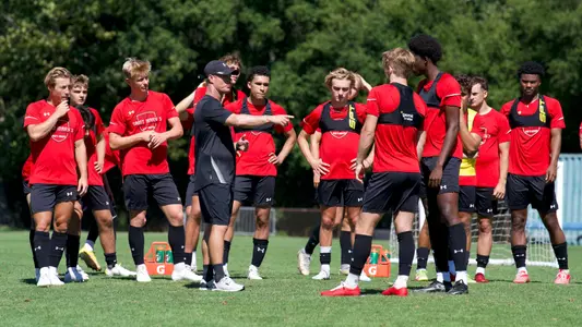 Adam Cooper instructs players at practice