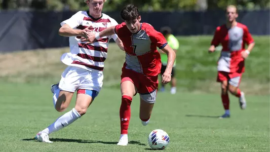 Cade Cowan pushes away from a defender