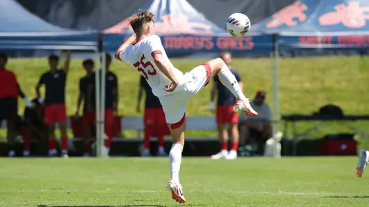 Wade Muttitt play a ball up high with his leg