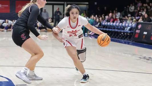 Aokuso dribbles around a defender
