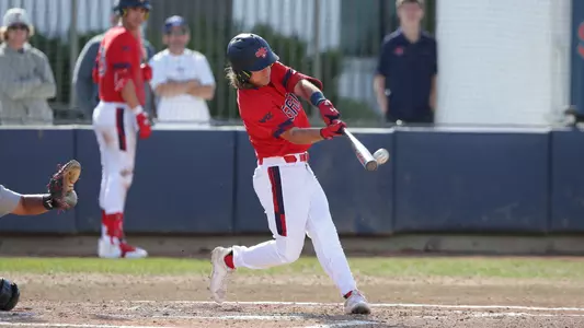 Gavin Napier swings in red uniform