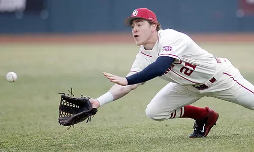Baseball Overcomes Rain Delays for 9-7 Win
