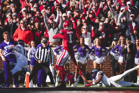 Oklahoma receiver Jayden Gibson drags a defender as he walks in for a touchdown in a game against TCU on Nov. 24, 2023 in Gaylord Family-Oklahoma Memorial Stadium in Norman, OK. (Photo by Morgan Givens/Oklahoma Athletics)