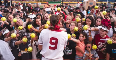 Oklahoma Softball catcher Kinzie Hansen signs autographs after a game where the Sooners defeated San Diego State part of the Mary Nutter Classic on Feb. 24, 2024 at the Big League Field of Dreams in Cathedral City California. (Photo by Morgan Givens/Oklahoma Athletics)