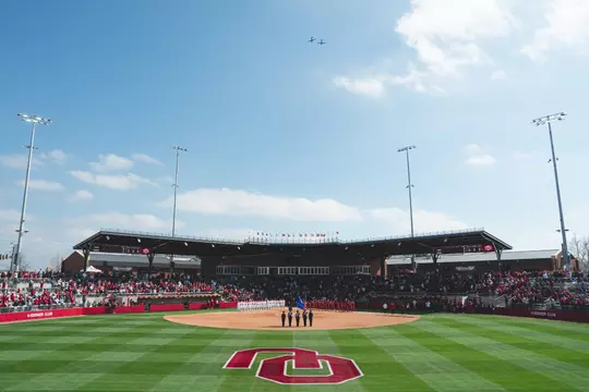 Fans and athletes stand for the national anthem during Opening Day at Loveās Stadium on Mar. 1, 2024. The contest between Oklahoma and Miami (OH) was the first game ever played in Loveās Field (Photo by Andrew Marsh/Oklahoma Athletics)