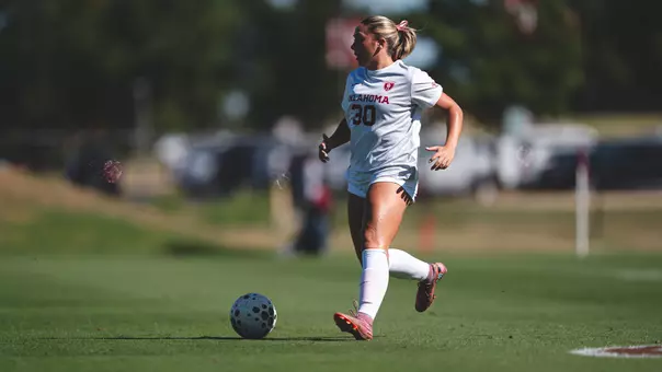 Claire Curran dribbles the ball up the field during a game against Texas