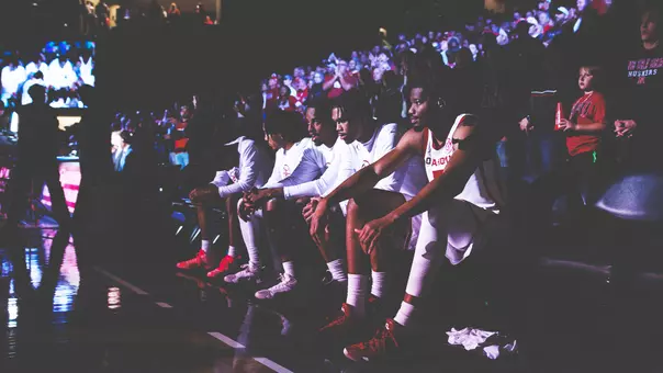 OU men's basketball starting five on the bench prior to the game against Nebraska
