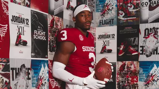 Robert Spears-Jennings photoshoot portrait photo in front of wall of Jordan themed images