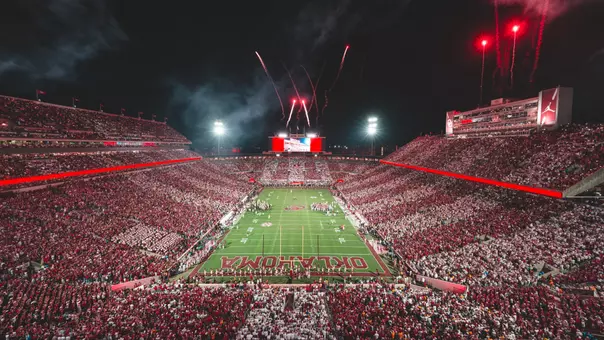 Gaylord Family - Oklahoma Memorial Stadium at night with striped crowd and fireworks