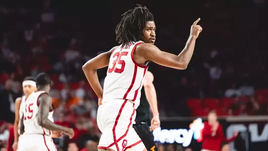 Glenn Taylor Jr. points as he runs down the court in a basketball game at Lloyd Noble Center