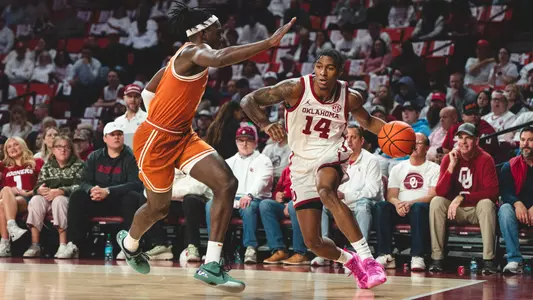 Jalon Moore drives against a Texas defender at Lloyd Noble Center