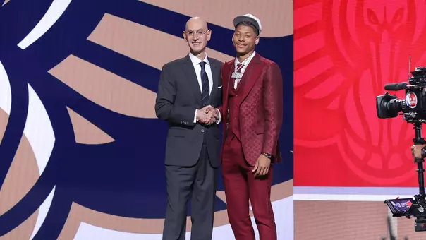 Jeremiah Fears shakes hands with NBA Commissioner Adam Silver on stage at the 2025 NBA Draft