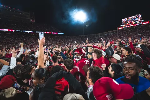 NORMAN, OK - November 23, 2024 - Oklahoma Offensive lineman Daniel Akinkunmi (#75) and fans storm the field during the game between the Alabama Crimson Tide and the Oklahoma Sooners at Gaylord Family - Oklahoma Memorial Stadium in Norman, OK. Photo By Morgan Givens/University of Oklahoma