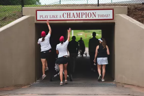 NORMAN, OK - May 05, 2025 - Oklahoma Women's Golf Head Coach Veronique Drouin-Luttrell and Audrey Rischer tap the Play Like a Champion Today sign during the NCAA Womenās Golf Norman Regional at Jimmie Austin Golf Club in Norman, OK. Photo By Morgan Givens/University of Oklahoma
