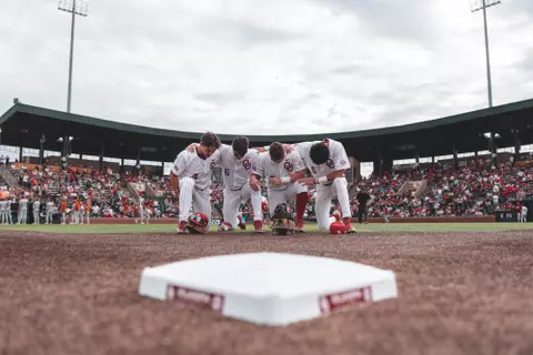 NORMAN, OK - May 15, 2025 - Oklahoma Infielder Mason Hamlin (#4), Oklahoma Infielder Kyle Branch (#6), Oklahoma Infielder Jaxon Willits (#7) and Oklahoma Infielder Dawson Willis (#5) pray during the game between the Texas Longhorns and the Oklahoma Sooners at L. Dale Mitchell Park in Norman, OK. Photo By Morgan Givens/University of Oklahoma