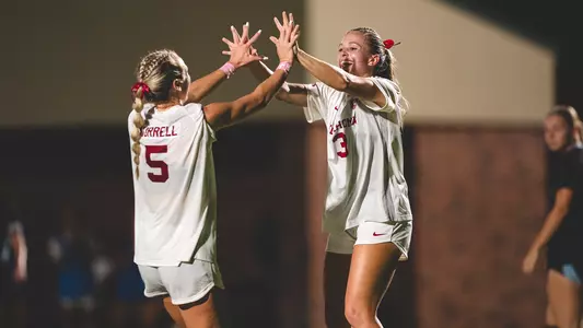 Hadley Murrell and Lexi Dendis high five after a goal against Louisiana Tech