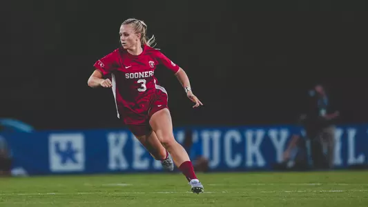 Lexi Dendis running for the ball in a game against Kentucky