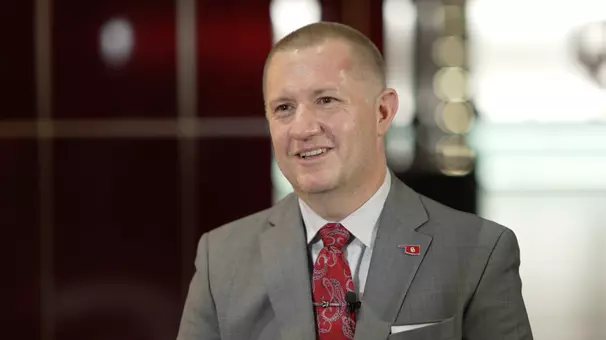 Photo of Roger Denny in a grey suit during a sit down interview with Toby Rowland
