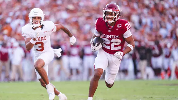 Oklahoma safety Peyton Bowen runs past a Texas defender as he returns an interception 42 yards against the Longhorns in a 27-24 OU win at the Cotton Bowl in Dallas on Oct. 10, 2026.