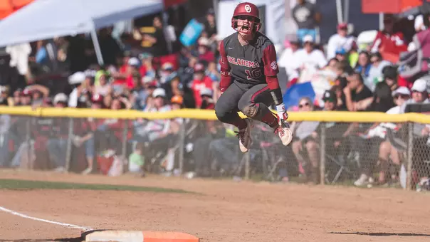 Abby Dayton jumping after a safe call at first base