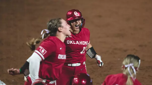 Isabela Emerling touching home plate after hitting the game-winning grand slam at Ole Miss