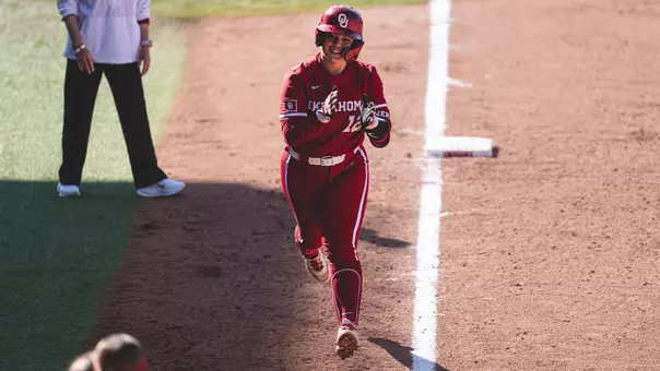 Lexi McDaniel rounding third base during a game