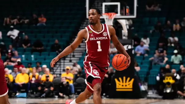 Xzayvier Brown in red uniform dribbles during OU's win over Colorado in the College Basketball Crown at MGM Grand Garden Arena in Las Vegas, Nevada on April 1, 2026