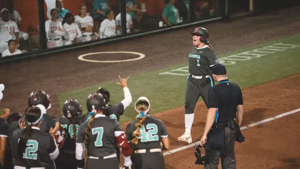 Kendall Wells rounding third base after the game-winning home run against Texas