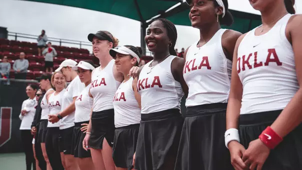 Gloriana Nahum and teammates stand for the National Anthem before their match against Texas. SEC Tourney Preview, Lead