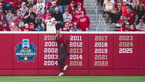 Ella Parker jumping to make a catch at the wall during the 3-2 loss against Arkansas