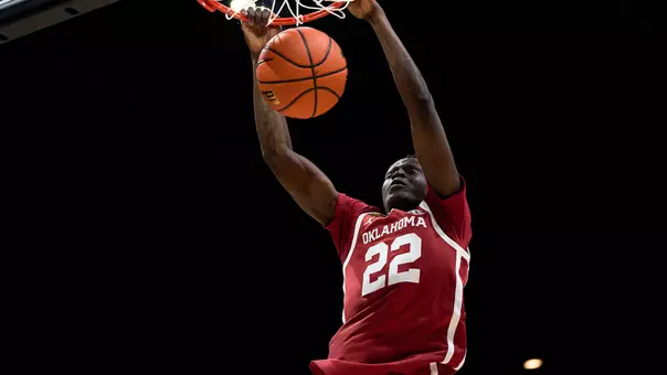 Kuol Atak in red uniform dunks during an OU basketball game