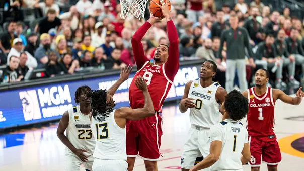 Kai Rogers in red uniform goes up for a basket amid defenders from West Virginia during the College Basketball Crown championship game at T-Mobile Arena in Las Vegas, Nevada on Sunday, April 5, 2026