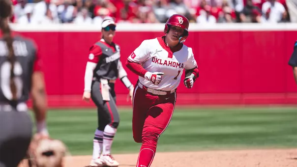 Kendall Wells rounding second base after hitting a home run
