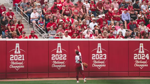 Abby Dayton points to the left field crowd at Love's Field