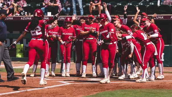 Kai Minor rounding third base and scoring after hitting a home run against Texas A&M