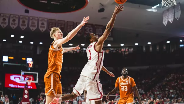 Xzayvier Brown goes up for a layup around defenders in a basketball game at Lloyd Noble Center in Norman, OK.