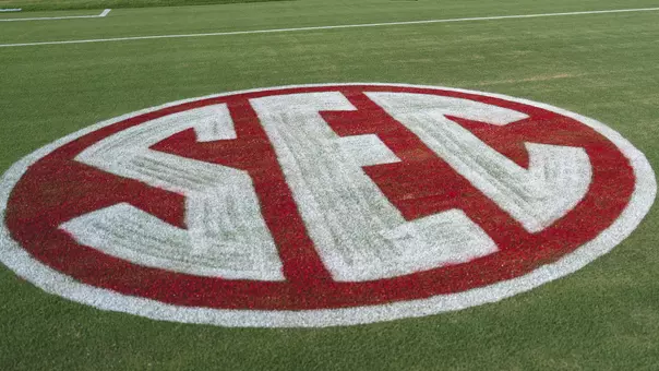 Picture of the SEC logo on the field at John Crain