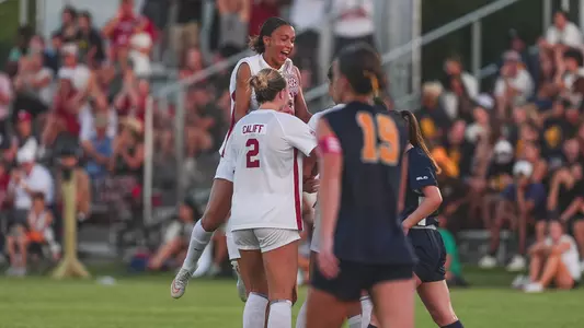 Ariana Ellison jumps into the huddle after Kennedy Kaiser's goal against East Texas A&M