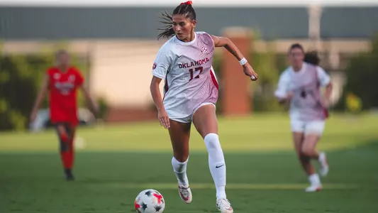 Kate McCallister dribbles the ball up the field during a game against Oklahoma State