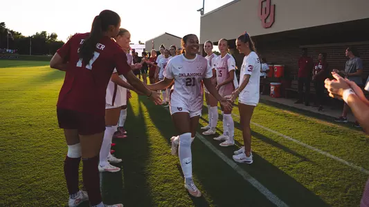 Kendall Campbell runs through the high-five line prior to a game against Missouri