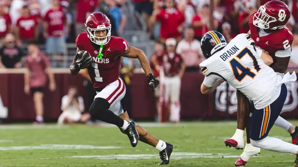 Isaiah Sategna III (1) returns a punt for a touchdown against UTEP while teammate Omarion Robinson (2) throws a block on a UTEP player on Friday, Sept. 4, 2026 at Gaylord Family - Oklahoma Memorial Stadium