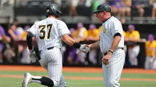 Southern Miss. outfielder Carson Paetow (37) and Southern Miss. Head Coach Scott Berry (40) celebrate the home run in a baseball game vs LSU
(Photo by Joe Harper/bgnphoto.com)