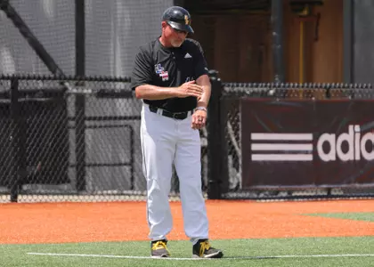 Southern Miss head coach Scott Berry gives signs to the runner at first base in a game against the Rice Owls . Saturday April 24, 2022 (Photo by Joe Harper/BigGold Photography)